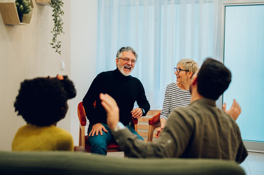 Senior people talking about their mental health on a group therapy session - Powered by Adobe