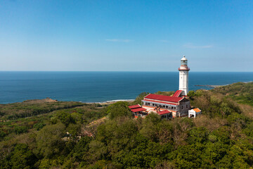 Fototapeta na wymiar Beautiful lighthouse on the cape Bojeador view from above. Ilocos Norte, Philippines.
