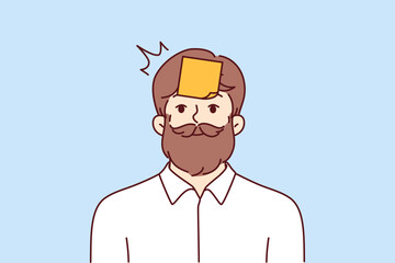 Hipster man with sticky notes on forehead looking at camera smiling. Hipster guy with mustache and beard tries to guess what is written on sticker playing with colleagues or friends 