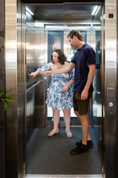 Person with a disability using lift in building