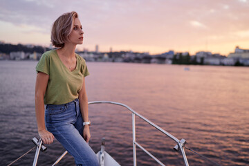 Luxury holiday on the yacht. Young happy woman on boat deck sailing the river Dnipro.