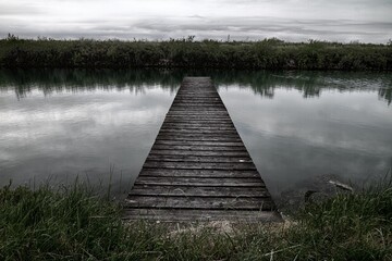 Scenic wooden pier in a lake on a gloomy day