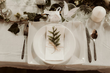 Top view of a table setting designed with decorative leaves and candles