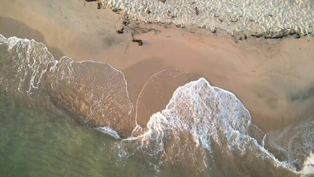 Aerial view of sea waves with foam on a Keramoti Beach in Greece