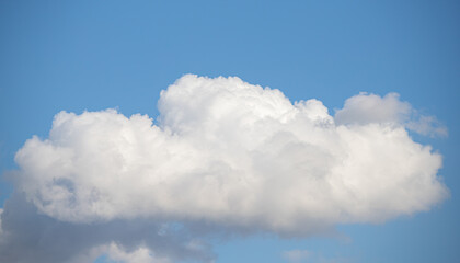 Naklejka na ściany i meble Blue sky with white fluffy clouds in sunny weather.