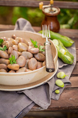 Hot boiled broad beans with parsley. Perfect summer snack.