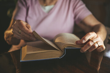 Senior woman reading an old book