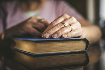 Elderly woman holding a book. 