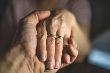 Senior couple holding hands.