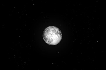 Obraz na płótnie Canvas Breathtaking view of the bright white full moon in the black starry night sky