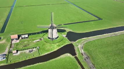 The windmill's sturdy structure and traditional design reflect Dutch engineering ingenuity. - Powered by Adobe