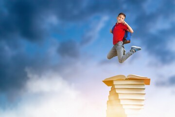 Back to school concept, Happy child on tower of books
