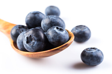 Fresh blueberries in wooden spoon