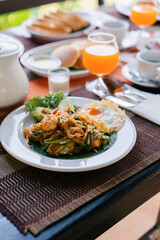 Thai food, breakfast with American food, khao Phad on old wooden table