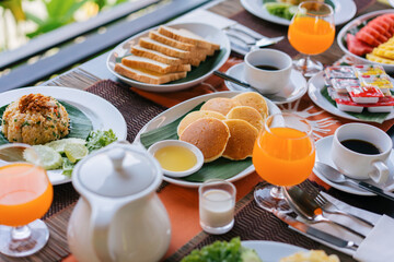 Thai food, breakfast with American food, khao Phad on old wooden table