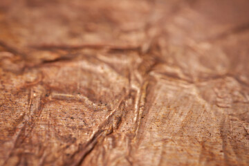 Extreme closeup of crumpled brass foil texture