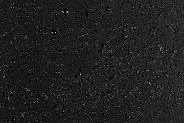 Water drops on dark stone
