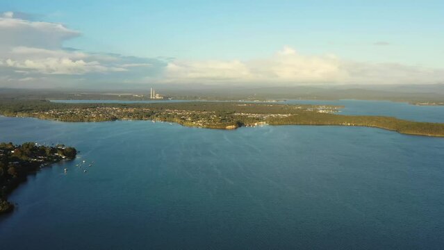 Lake Macquarie shoreline in aerial panning morning light – Australian lagoon.
