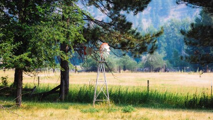 Small windmill on the field in the mountain in summer