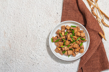 Fried teriyaki Tofu with scallions and sesame seeds. Healthy vegan meatless meal rich in protein