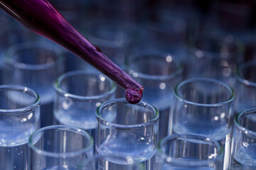 Pipette dropping fluid into test tube