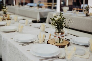 Set table for a wedding ceremony,and flower decoration on tables, the concept of celebration of love