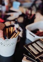 Makeup brushes on the table, with makeup equipment in the background, the concept of beautification