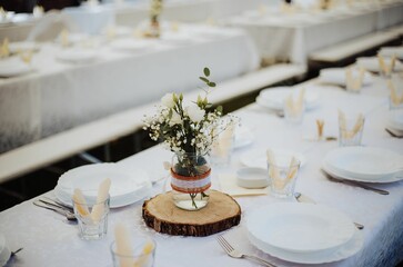 Set table for a wedding ceremony,and flower decoration on tables, the concept of celebration of love