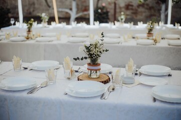 Set table for a wedding ceremony,and flower decoration on tables, the concept of celebration of love