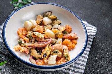 seafood salad shrimp, mussel, scallop, octopus meal food snack on the table copy space food background rustic top view 
