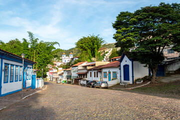 Sabar&aacute;. Beautiful colorful old mansions in the historic city of Sabar&aacute;. Brazil. Blue sky. Stone-paved street.