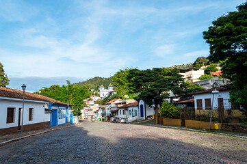 Sabar&aacute;. Beautiful colorful old mansions in the historic city of Sabar&aacute;. Brazil. Blue sky. Stone-paved street.