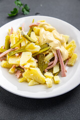 fresh potato salad, gherkin, sausage, mayonnaise ready to eat meal food snack on the table copy space food background rustic top view