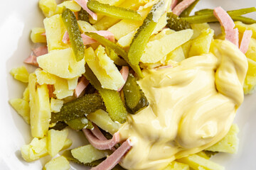 fresh potato salad, gherkin, sausage, mayonnaise ready to eat meal food snack on the table copy space food background rustic top view