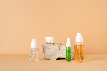 Set of cosmetic products and natural stone. Clear liquid and white cream. Beauty concept. Copy space