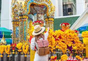 Asian woman travel in erawan shrine Bangkok city
