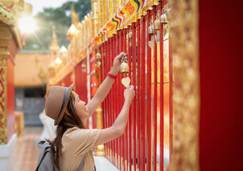 Asian traveller woman travel in Wat phrathat doi suthep with buddha statue in Chiang mai