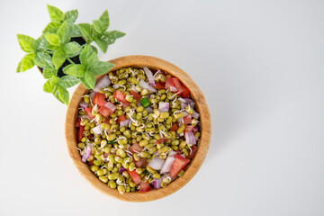 Sprouting green gram bean Indian salad with Onion, coriander leaf , green chili and tomatoes. Indian sprouting gram bean salad with isolated background.