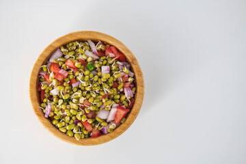 Sprouting green gram bean Indian salad with Onion, coriander leaf , green chili and tomatoes. Indian sprouting gram bean salad with isolated background...