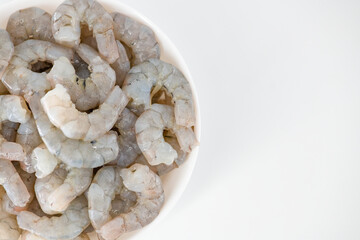 Fresh Raw shrimps cut and cleaned and kept it in a white bowl. Raw shrimps in white bowl and isolated in white background. Selective focused image...