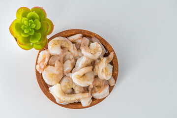 Fresh Raw shrimps cleaned and kept it in a wooden bowl. Raw shrimps in wooden bowl and isolated in white background...
