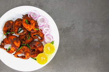 Cooking deep frying of crispy tasty fish. homemade chettinad style. Deep South Indian spicy fish fry on a plate with isolated background. Fresh spicy fish fry