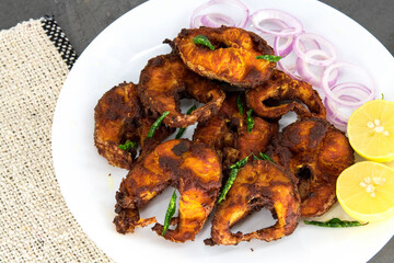 Cooking deep frying of crispy tasty fish sea food in plate with low oil for diet cholesterol control dish by south indian tamilnadu homemade chettinad style..Deep South Indian spicy fish fry 