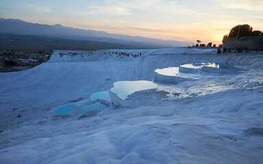 A stunning sunset at Pamukkale, Turkey. Thermal pools and travertines set against vibrant sky in a majestic natural landscape