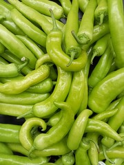pile of large green chilies that are suitable as an addition to dishes
