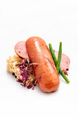Fried sausages with vegetables on a white background