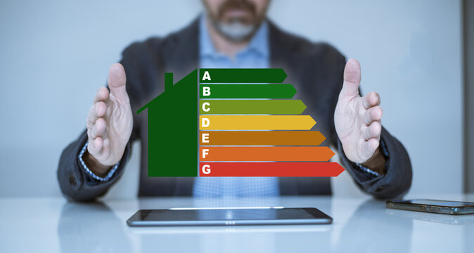 Man calculating energy buildings efficiency class. Ecological and bio energetic house concept.