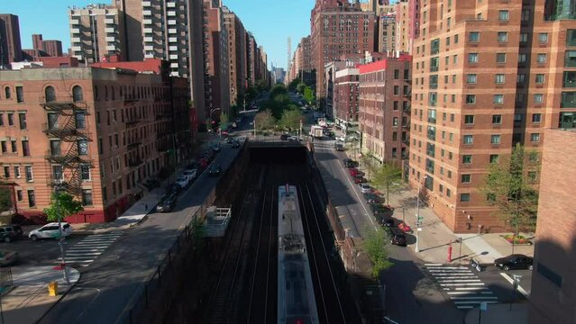 Trains entering and leaving subway tunnel NYC Park Ave 96th street upper east side rush hour traffic