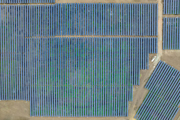 Aerial drone shot. Solar panels farm in a field.
