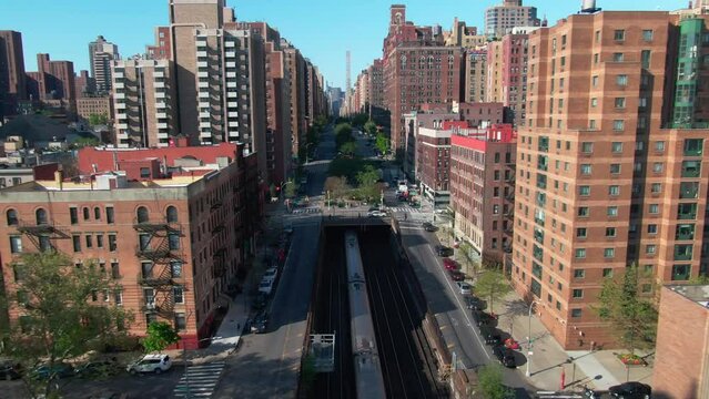 Trains entering and leaving subway tunnel NYC Park Ave rising drone show reveal midtown Manhattan buildings 96th street upper east side rush hour traffic